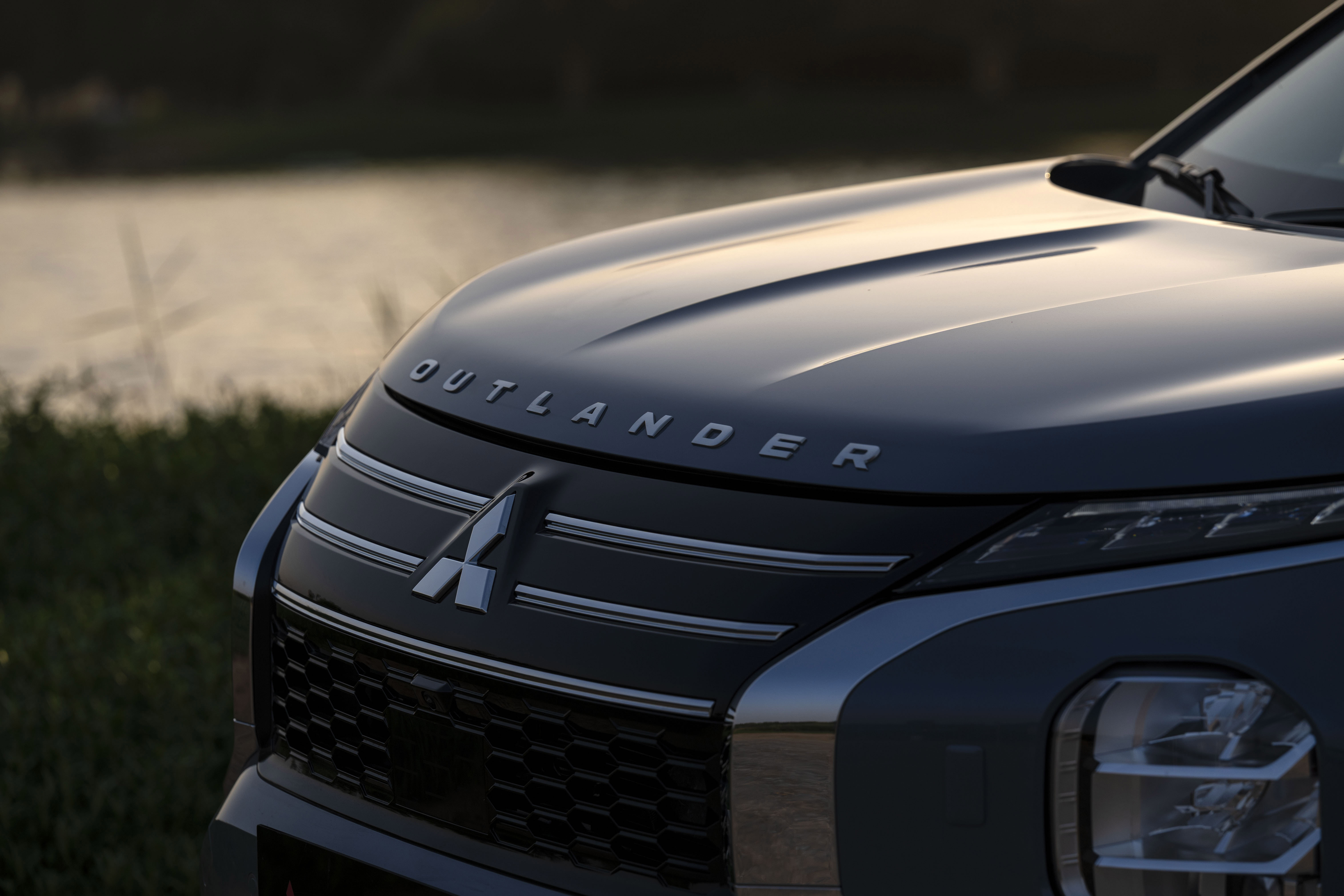 Mitsubishi Outlander front grille close-up at golden hour