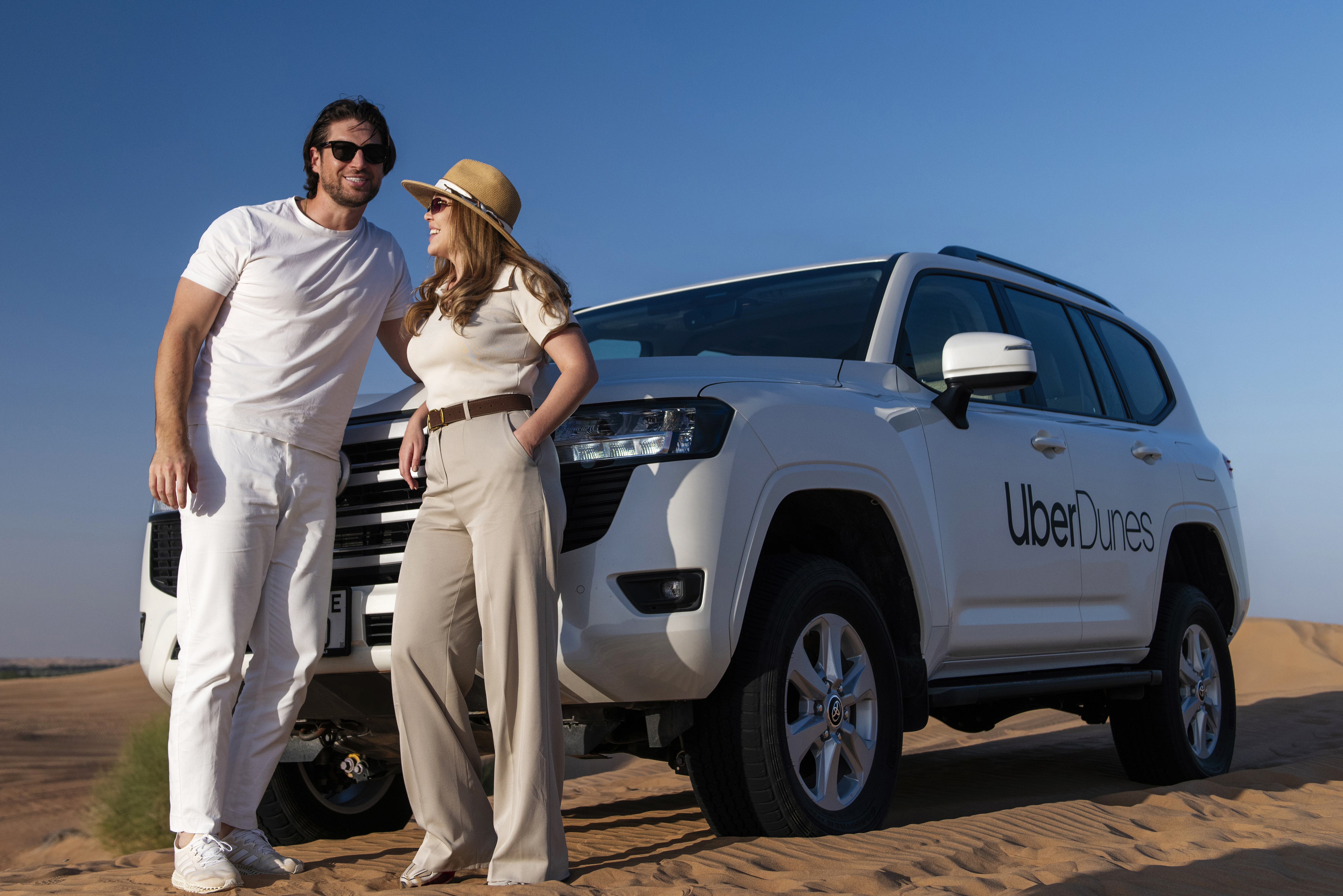 Couple on a desert dune adventure with Uber Dunes, UAE